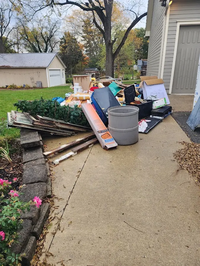 Dumpster being loaded with debris for Estate Cleanout Dumpster Rental in Little Elm
